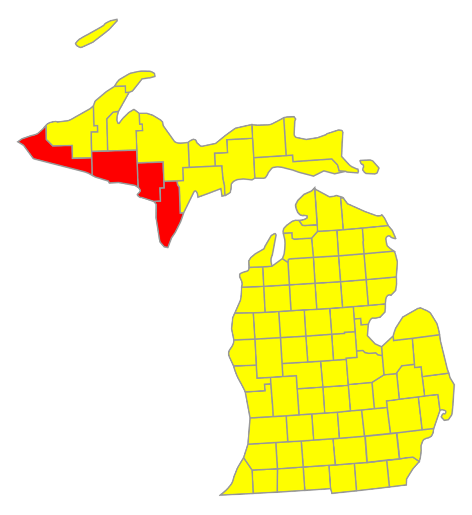 A map of counties in Michigan. Most are labeled yellow, but four at the far western edge of the Upper Peninsula are labeled red.